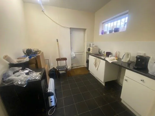 MIXED USE INVESTMENT: A PART LET DETACHED BUILDING WITH 2 GROUND FLOOR COMMERCIAL UNITS AND A RESIDENTIAL FLAT ABOVE AND BUILDERS YARD TO REAR