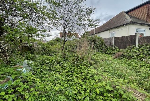 GARAGES / LAND INVESTMENT: A VACANT FREEHOLD SITE HOUSING TWO GARAGES / BUILDINGS IN NEED OF REPAIR / RENOVATION WITH ADDITIONAL LAND TO THE REAR 