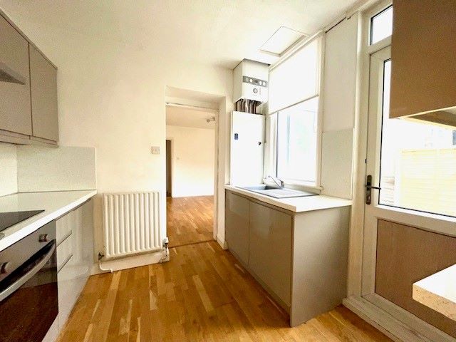 RESIDENTIAL INVESTMENT: A TWO BED GROUND FLOOR FLAT WITH RESIDENTS PARKING PLUS A LONG LEASE AND SHARED GARDEN LOCATED CLOSE TO THE RAILWAY STATION
