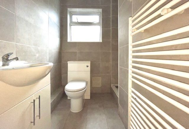RESIDENTIAL INVESTMENT: A TWO BED GROUND FLOOR FLAT WITH RESIDENTS PARKING PLUS A LONG LEASE AND SHARED GARDEN LOCATED CLOSE TO THE RAILWAY STATION
