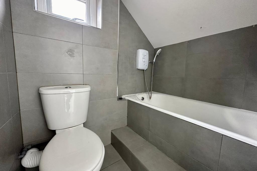 RESIDENTIAL INVESTMENT: A SUBSTANTIAL FREEHOLD BUILDING WITH CAR PARK USED AS A HOUSE OF MULTIPLE OCCUPANCY COMPRISING 9 STUDIOS AND 10 ROOMS