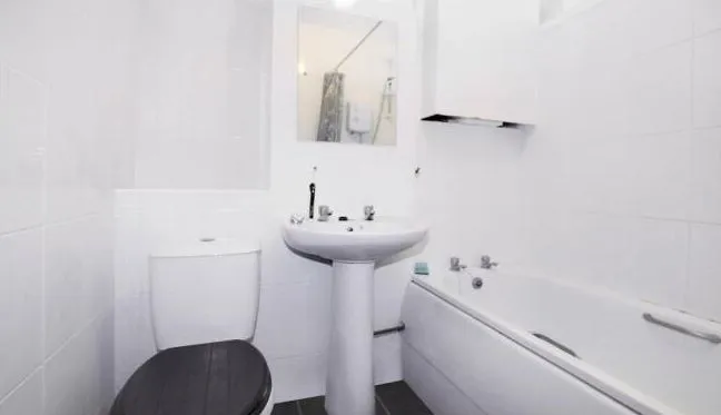 RESIDENTIAL: A VACANT LEASEHOLD ONE BEDROOM GROUND FLOOR MAISONETTE BENEFITING FROM ITS OWN DRIVEWAY, GARAGE AND COURTYARD GARDEN.