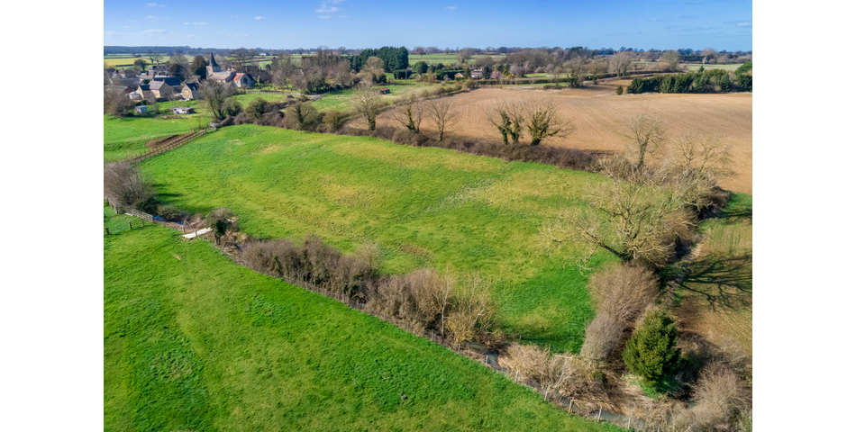 Approximately 6.57 acres of permanent pasture on the edge of this popular village.