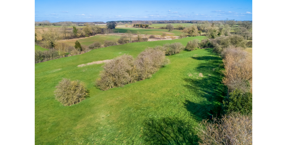 Approximately 6.57 acres of permanent pasture on the edge of this popular village.