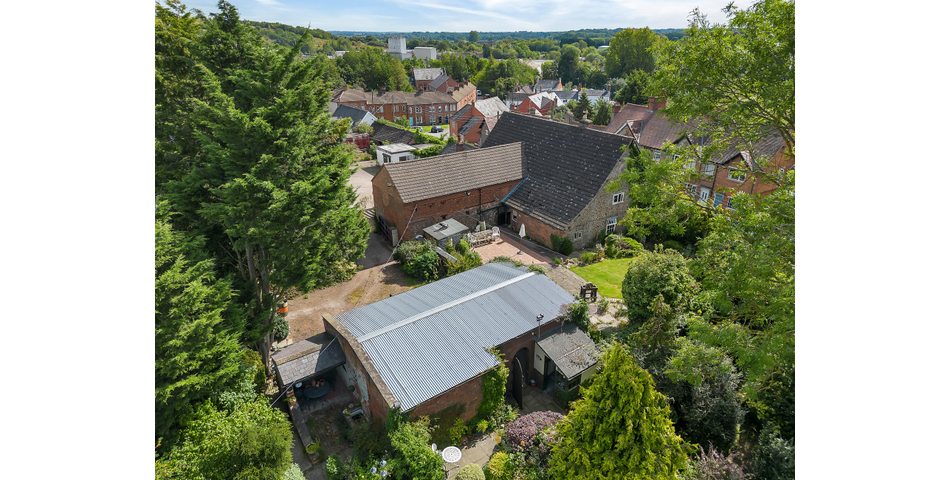 An extensive site to include farmhouse, outbuildings and gardens.