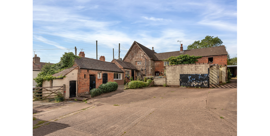 An extensive site to include farmhouse, outbuildings and gardens.