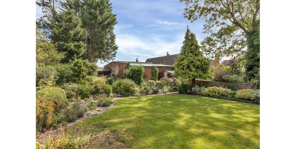 An extensive site to include farmhouse, outbuildings and gardens.