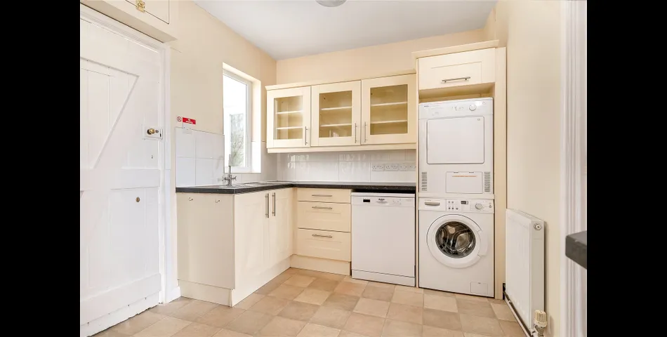 A two-bedroom semi-detached red brick cottage with generous gardens and parking