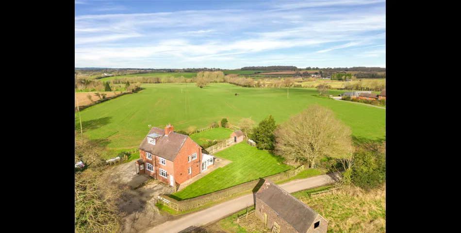 A two-bedroom semi-detached red brick cottage with generous gardens and parking