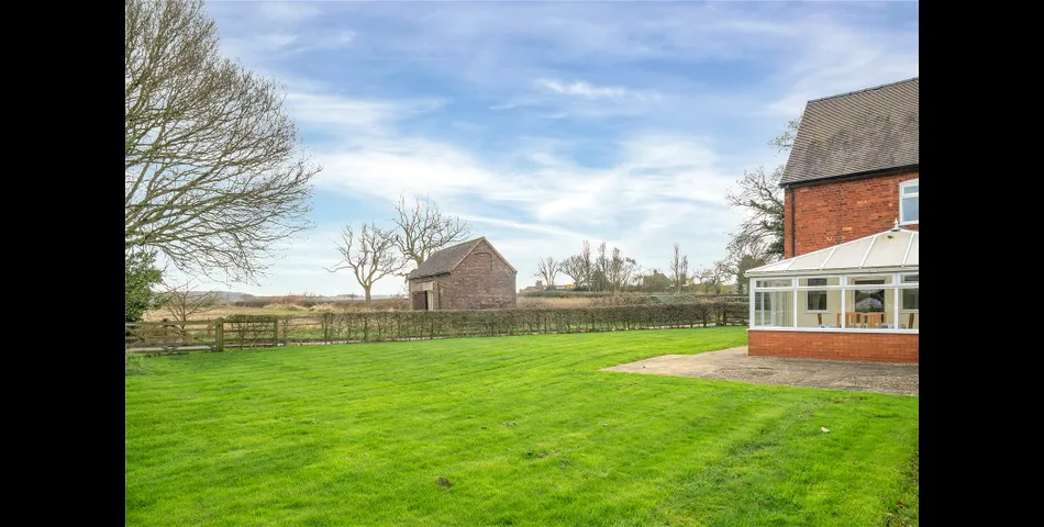 A two-bedroom semi-detached red brick cottage with generous gardens and parking