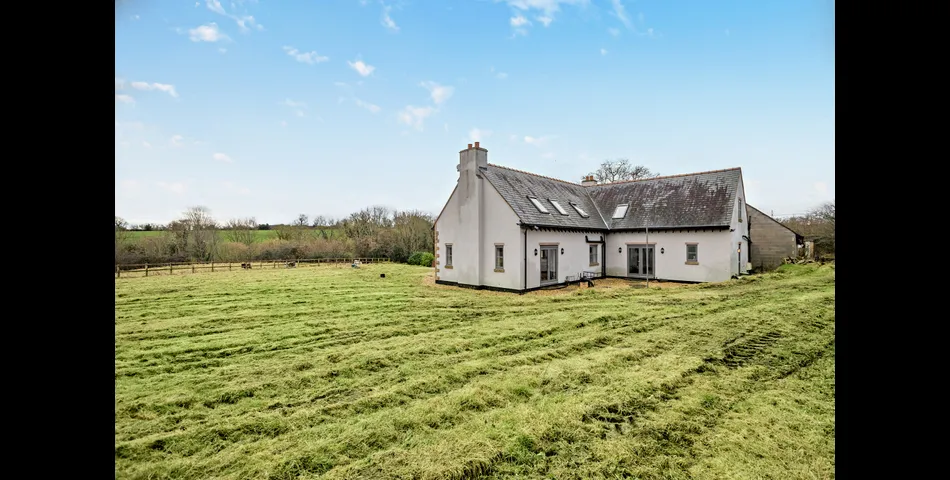 A generous family residence in c.3.68 acres of land within a village setting.