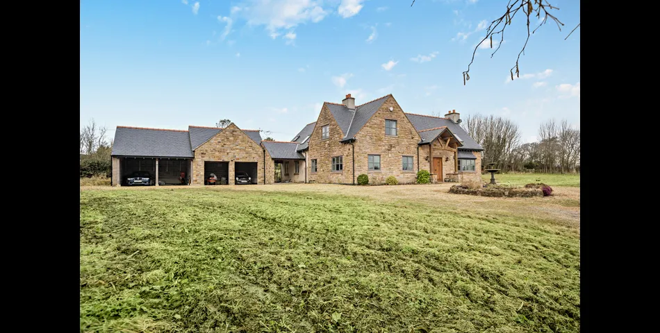 A generous family residence in c.3.68 acres of land within a village setting.