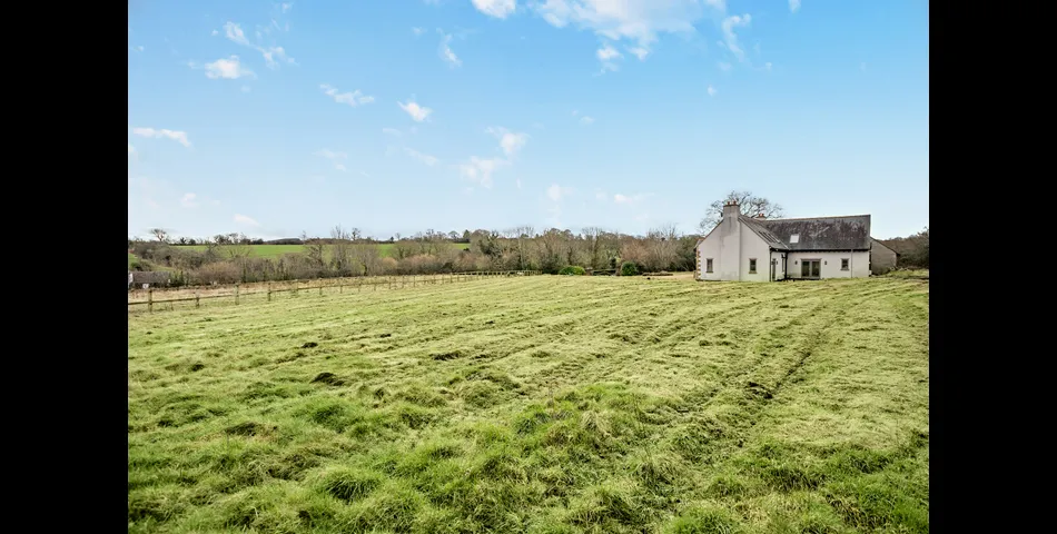 A generous family residence in c.3.68 acres of land within a village setting.