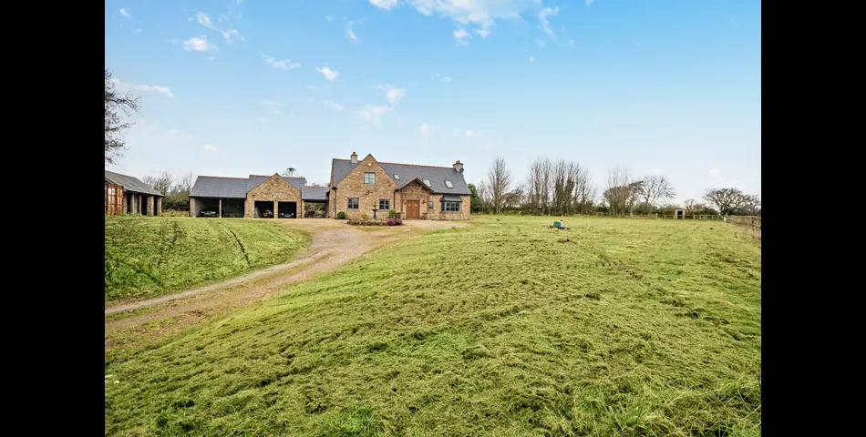 A generous family residence in c.3.68 acres of land within a village setting.