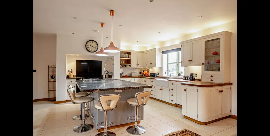 A generous family residence in c.3.68 acres of land within a village setting.