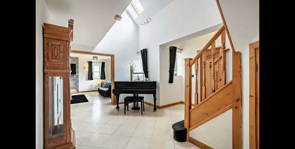 A generous family residence in c.3.68 acres of land within a village setting.