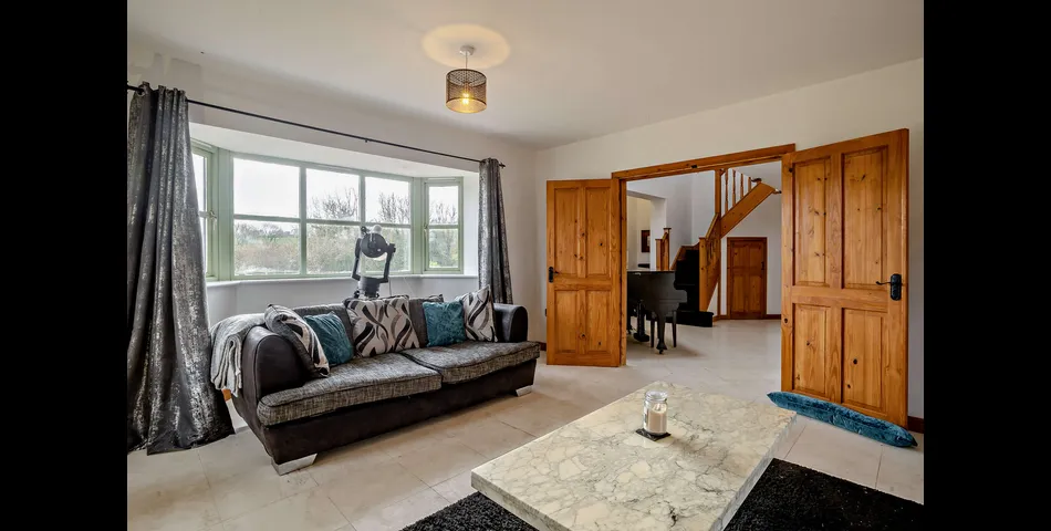 A generous family residence in c.3.68 acres of land within a village setting.