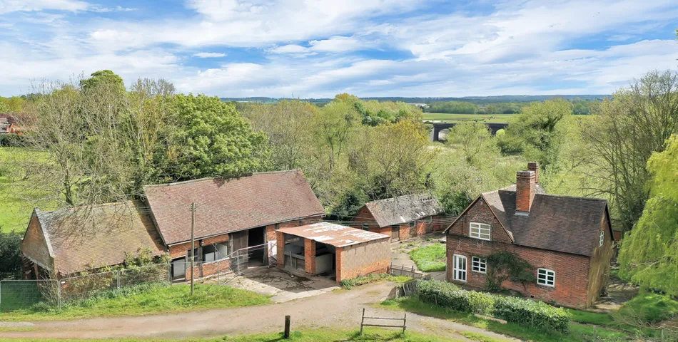 A smallholding with a cottage in need of total refurbishment, outbuildings and about 7.35 acres of land