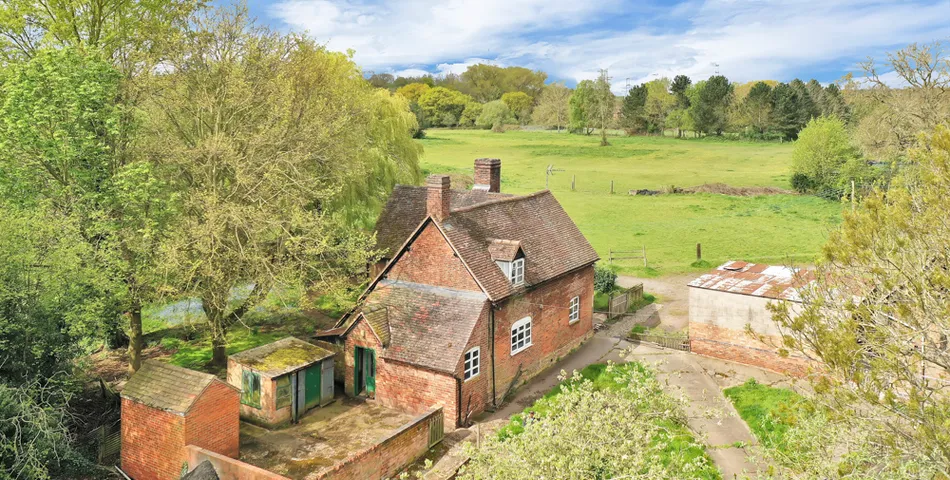 A smallholding with a cottage in need of total refurbishment, outbuildings and about 7.35 acres of land