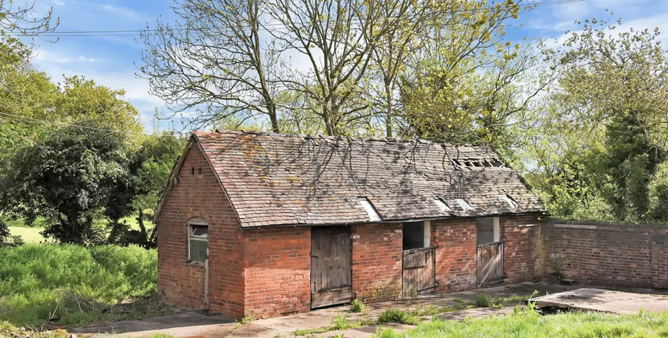 A smallholding with a cottage in need of total refurbishment, outbuildings and about 7.35 acres of land