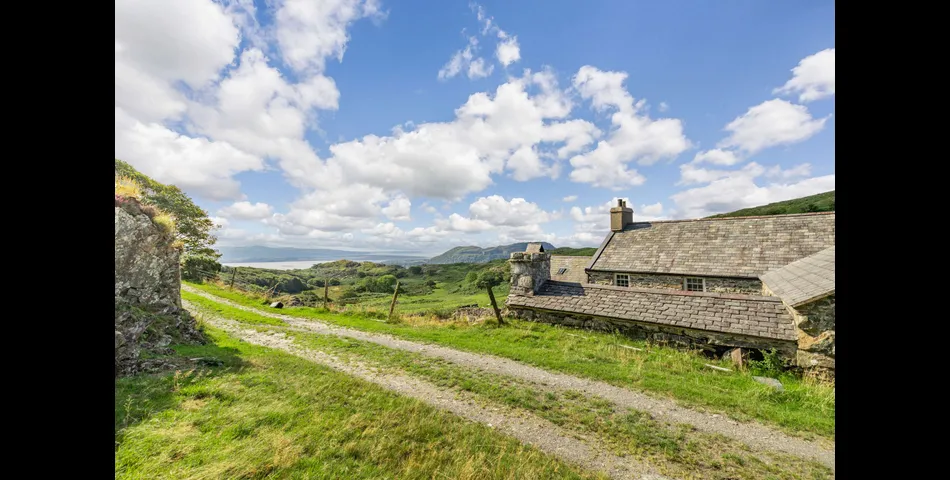 A traditional Welsh stone farmhouse requiring renovation, along with ancillary buildings, in an elevated setting with spectacular views towards Cardigan Bay and Snowdonia National Park, within 3.29 acres