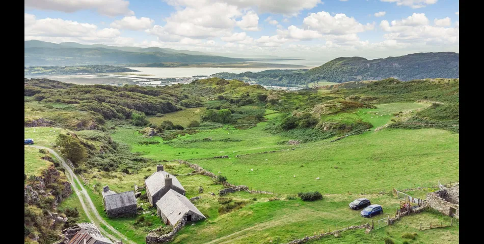 A traditional Welsh stone farmhouse requiring renovation, along with ancillary buildings, in an elevated setting with spectacular views towards Cardigan Bay and Snowdonia National Park, within 3.29 acres