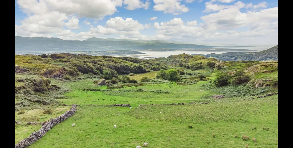 A traditional Welsh stone farmhouse requiring renovation, along with ancillary buildings, in an elevated setting with spectacular views towards Cardigan Bay and Snowdonia National Park, within 3.29 acres