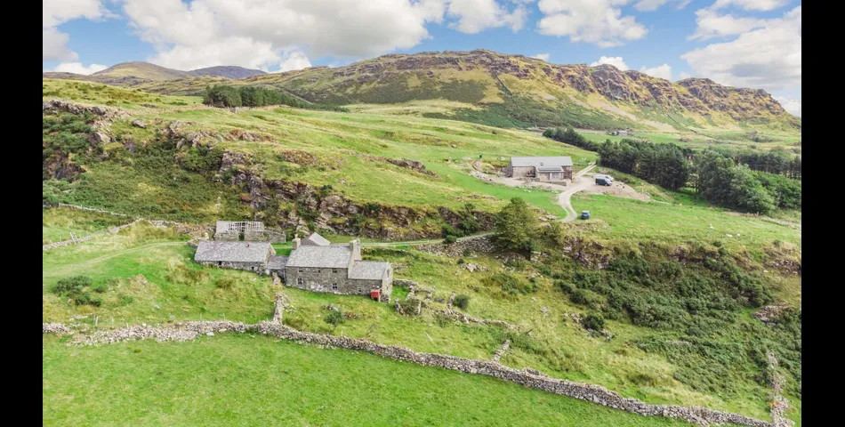 A traditional Welsh stone farmhouse requiring renovation, along with ancillary buildings, in an elevated setting with spectacular views towards Cardigan Bay and Snowdonia National Park, within 3.29 acres