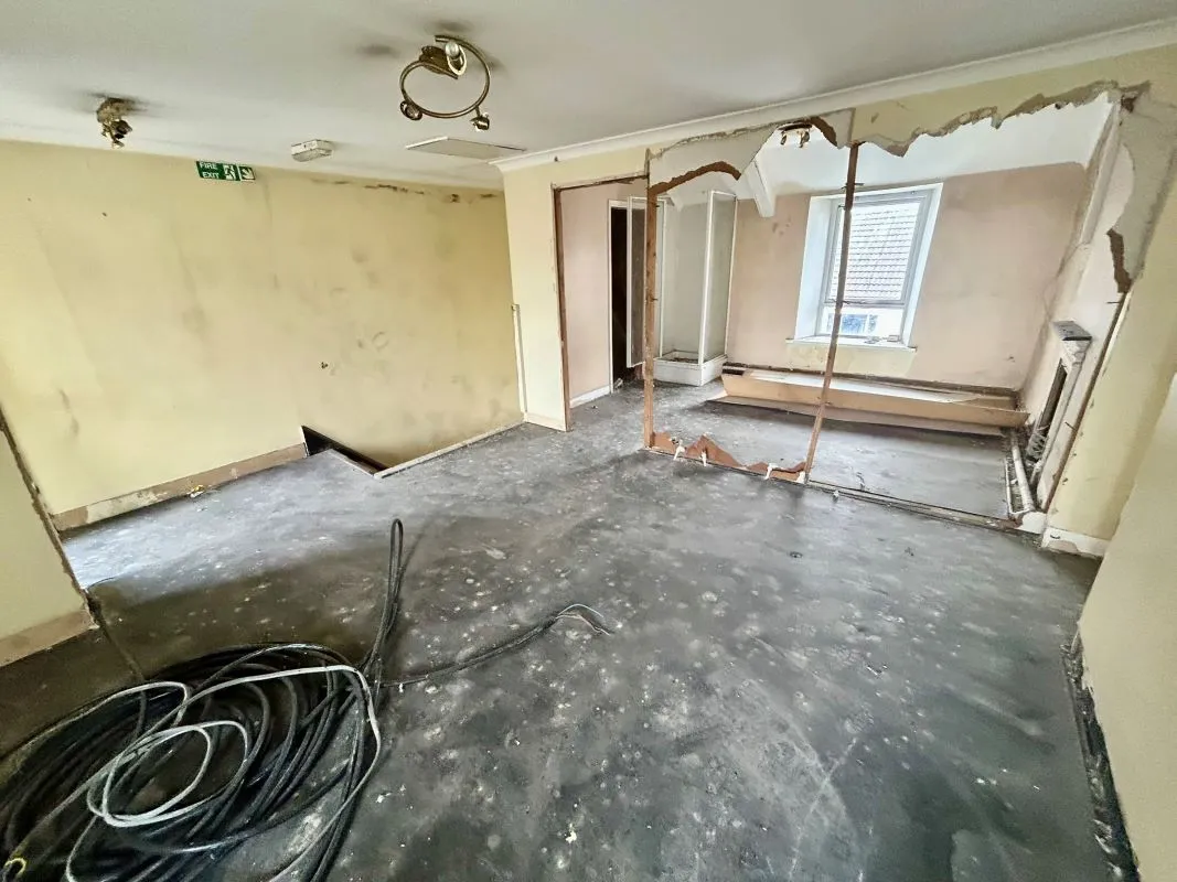 Opportunity to acquire this three storey end of terrace property in Neath. Three retail units to the ground floor with residential redevelopment opportunity to upper floors and a large rear car park.