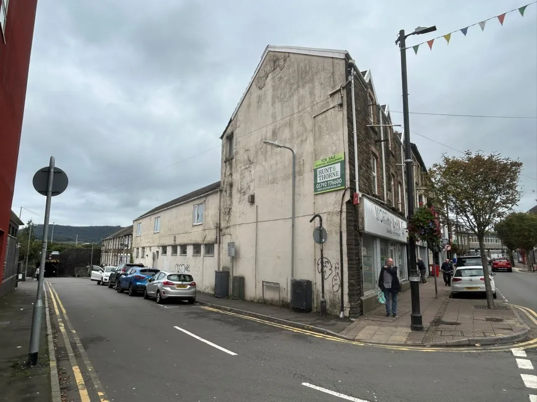 Opportunity to acquire this three storey end of terrace property in Neath. Three retail units to the ground floor with residential redevelopment opportunity to upper floors and a large rear car park.