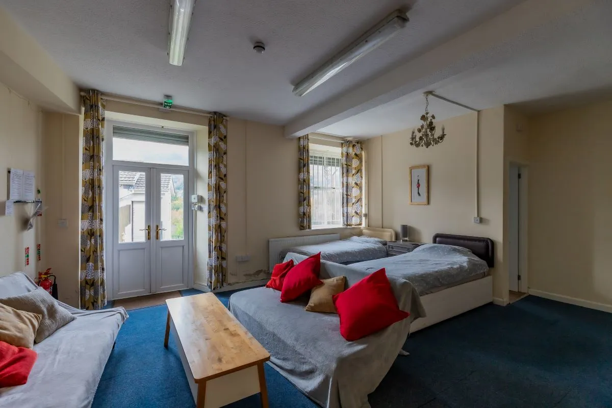 Converted chapel and further large outbuilding currently operated as a 14-16 bed short-term let/hostel with shared rooms and four bathrooms. Potential for development, subject to consents.