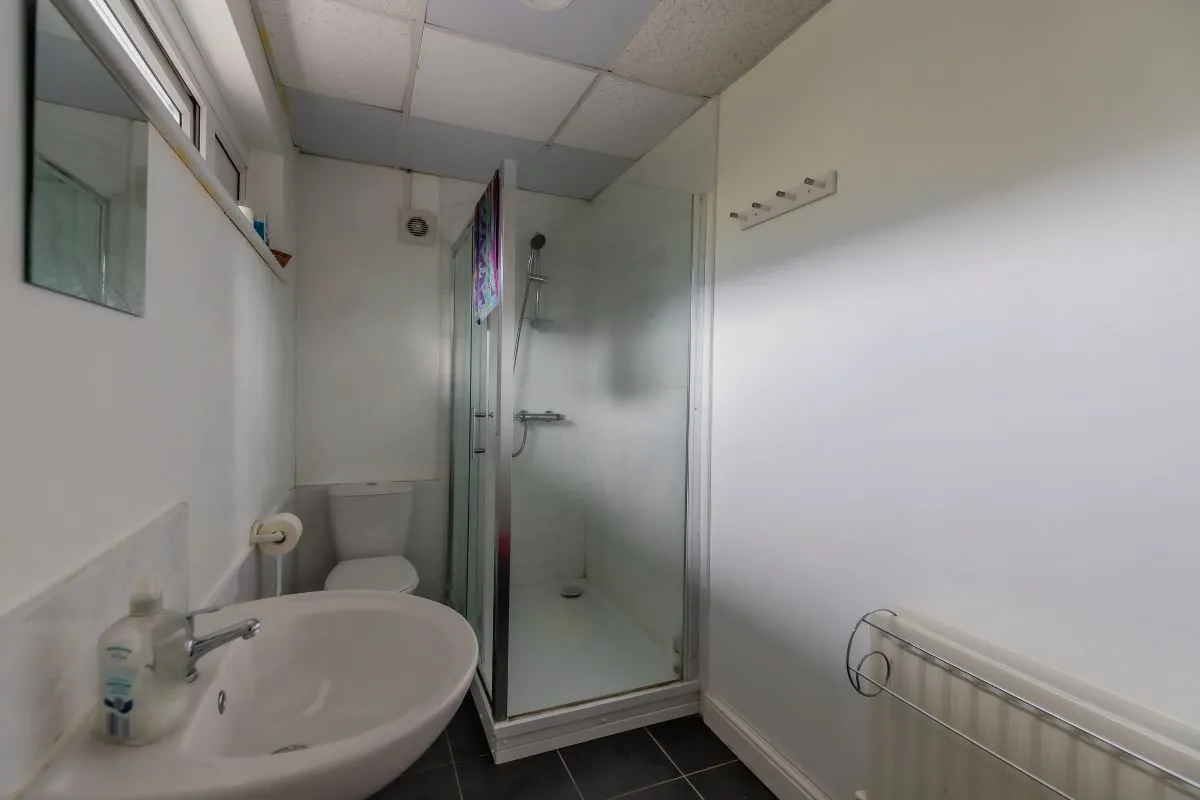 Converted chapel and further large outbuilding currently operated as a 14-16 bed short-term let/hostel with shared rooms and four bathrooms. Potential for development, subject to consents.