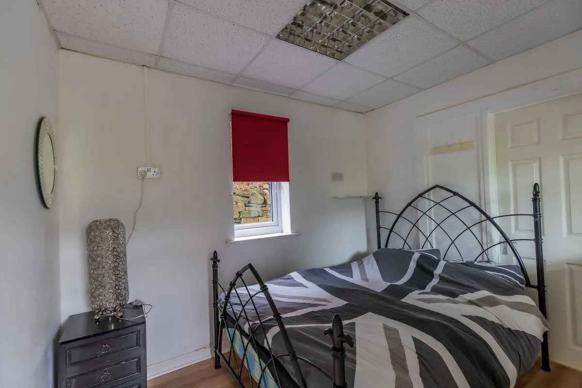 Converted chapel and further large outbuilding currently operated as a 14-16 bed short-term let/hostel with shared rooms and four bathrooms. Potential for development, subject to consents.