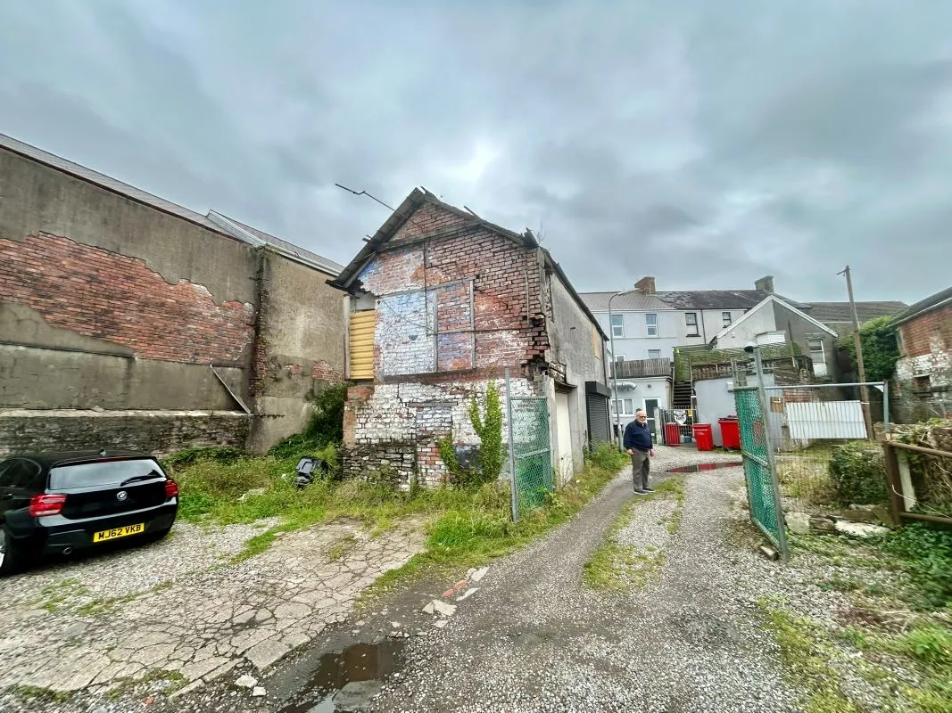 Opportunity to acquire this three storey end of terrace property in Neath. Two commercial units to the ground floor plus a barbers shop with residential redevelopment opportunity to upper floors and a large rear car park with a part-outbuilding also included.