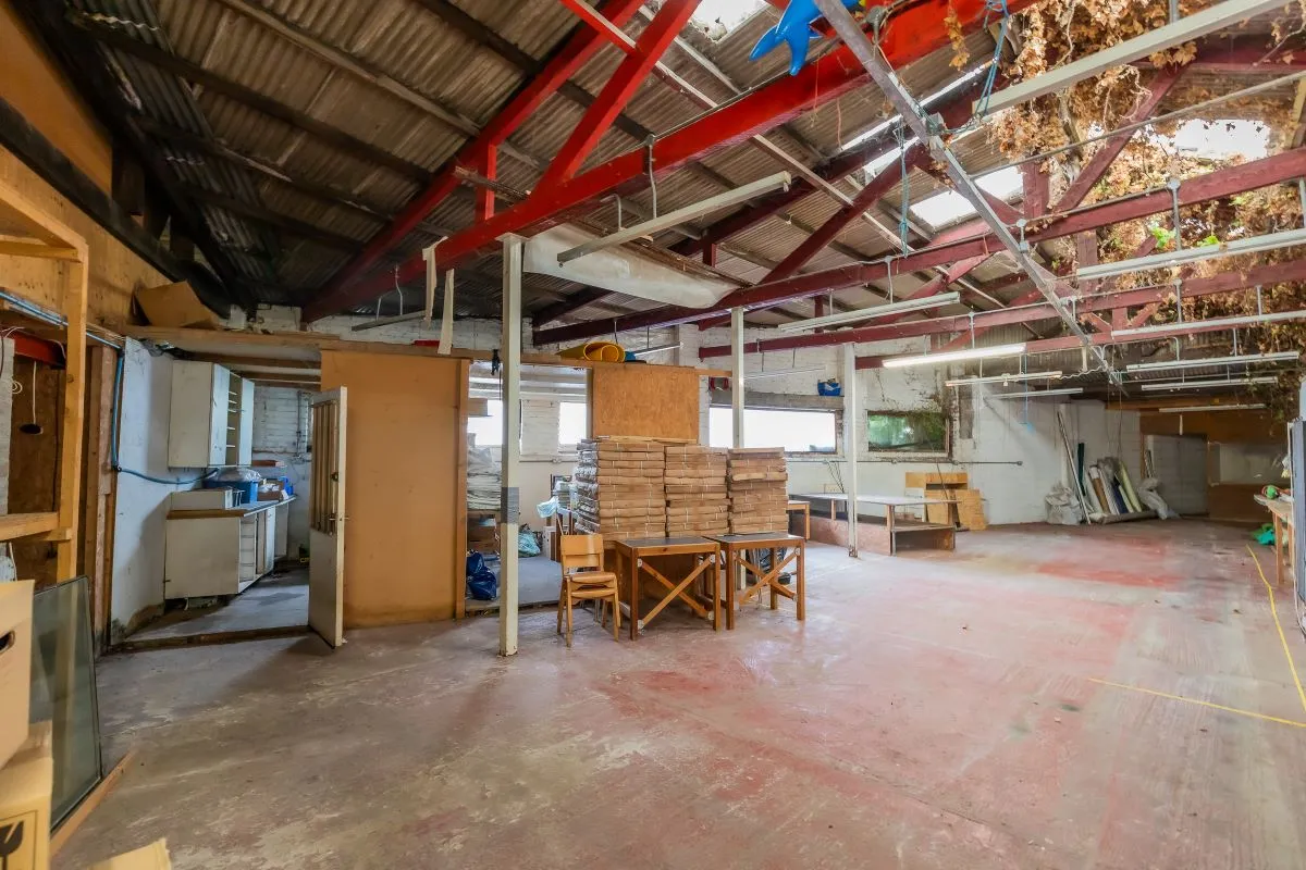 Large warehouse/workshop extending to approximately 5400 sq ft (502 sqm) which could be suitable for a wide variety of uses or complete redevelopment, subject to any necessary consents.