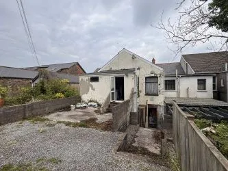 Opportunity to acquire this freehold mixed use building with ground floor commercial unit and first floor rooms. Rear parking and development land in Maesteg.