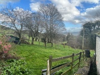 A three bedroom character cottage in a charming rural location on the outskirts of Llanrhaeadr Ym Mochnant with views over the surrounding countryside and offering scope for improvement.