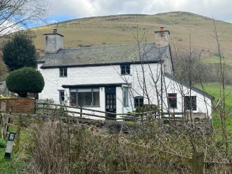 A three bedroom character cottage in a charming rural location on the outskirts of Llanrhaeadr Ym Mochnant with views over the surrounding countryside and offering scope for improvement.