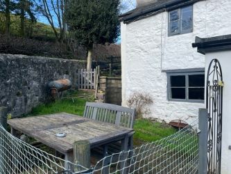A three bedroom character cottage in a charming rural location on the outskirts of Llanrhaeadr Ym Mochnant with views over the surrounding countryside and offering scope for improvement.