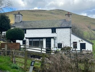 A three bedroom character cottage in a charming rural location on the outskirts of Llanrhaeadr Ym Mochnant with views over the surrounding countryside and offering scope for improvement.