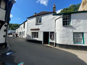 For Sale by online Auction, bidding opens Thursday 29th August at 10:00am, is a ground floor retail unit in the historic fishing village of Polperro, Cornwall.