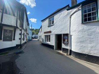 For Sale by online Auction, bidding opens Thursday 29th August at 10:00am, is a ground floor retail unit in the historic fishing village of Polperro, Cornwall.