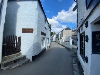 For Sale by online Auction, bidding opens Thursday 29th August at 10:00am, is a ground floor retail unit in the historic fishing village of Polperro, Cornwall.