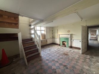 This remarkable opportunity includes an imposing Grade II Listed Building, previously used as offices, with approved planning permission for conversion into a stunning 5-bedroom residence spread across three floors. Additionally, planning consent has been granted to transform the existing garage outbuilding into a charming single-story, 2-bedroom detached home.