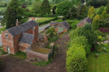 This remarkable opportunity includes an imposing Grade II Listed Building, previously used as offices, with approved planning permission for conversion into a stunning 5-bedroom residence spread across three floors. Additionally, planning consent has been granted to transform the existing garage outbuilding into a charming single-story, 2-bedroom detached home.