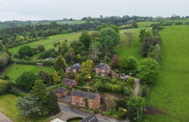 This remarkable opportunity includes an imposing Grade II Listed Building, previously used as offices, with approved planning permission for conversion into a stunning 5-bedroom residence spread across three floors. Additionally, planning consent has been granted to transform the existing garage outbuilding into a charming single-story, 2-bedroom detached home.