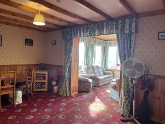 Town and Country Property Auctions proudly presents Polcraig Guest House, a modern detached property nestled in the heart of Lochinver, Scotland.