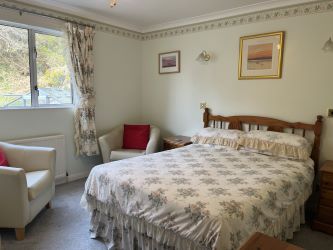 Town and Country Property Auctions proudly presents Polcraig Guest House, a modern detached property nestled in the heart of Lochinver, Scotland.