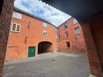 Offered to the market via auction is this unique and spacious loft-style duplex apartment, set within the impressive Grade II listed Tean Hall Mills development. Converted in 2013 to a high standard, the property is situated in the former Warehouse building and retains many original features including exposed beams, cast iron pillars, and vaulted ceilings.