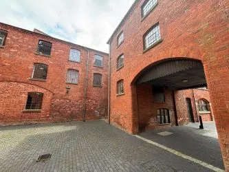 Offered to the market via auction is this unique and spacious loft-style duplex apartment, set within the impressive Grade II listed Tean Hall Mills development. Converted in 2013 to a high standard, the property is situated in the former Warehouse building and retains many original features including exposed beams, cast iron pillars, and vaulted ceilings.